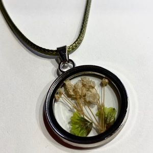Encased floral pendant